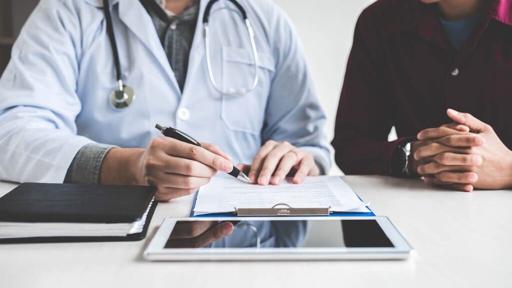 A healthcare professional in a white coat consulting with a patient to discuss a clinical plan for overcoming insulin resistance and restoring metabolic health