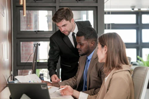 Corporate administrative team reviewing data documents and strategic workflows in an office, showcasing administration and operational career opportunities for Dignity health jobs.